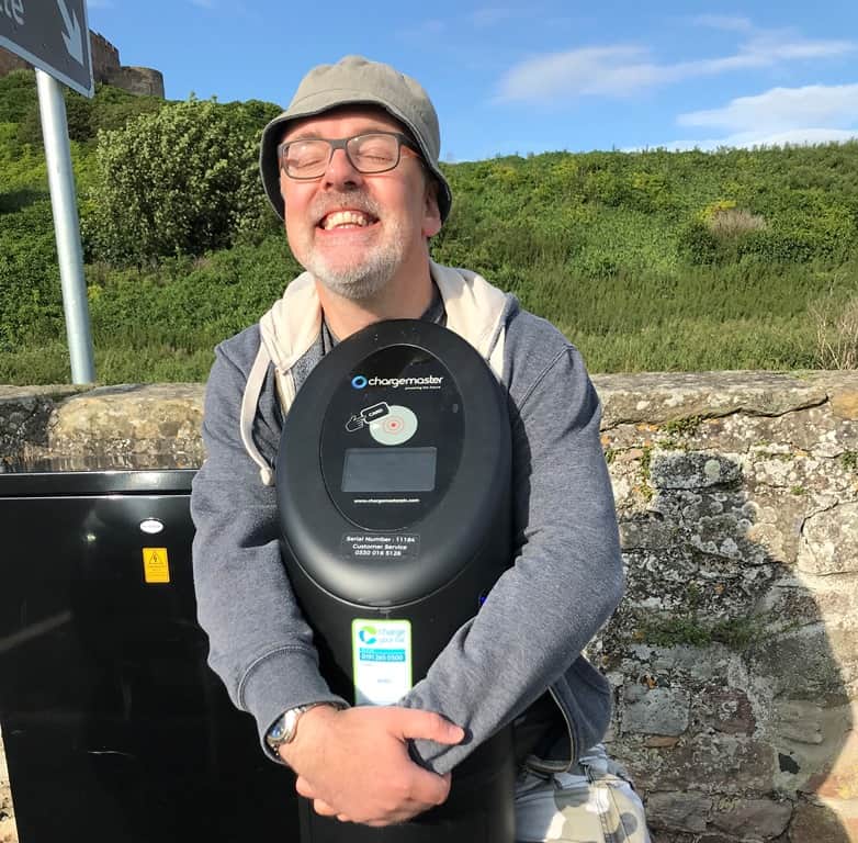 Julian Skidmore at an EV charge point